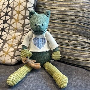 Anthropologie stuffed green alligator holding a teddy bear